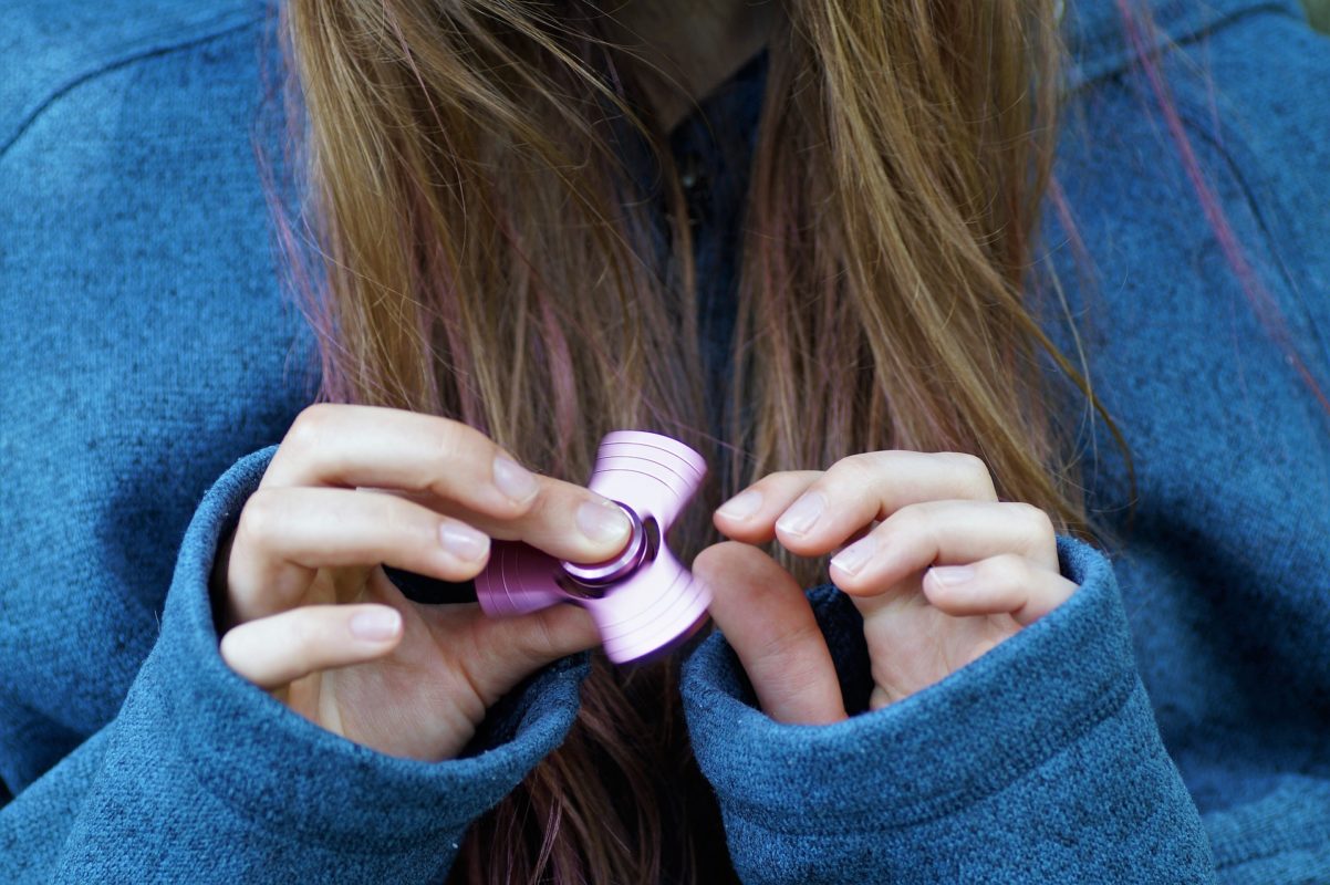 Fidget spinner in woman's hands