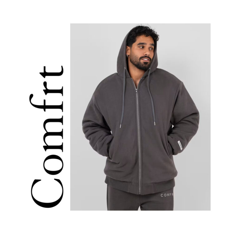 Comfrt weighted hoodie and sweatpants on a posed model (male presenting)